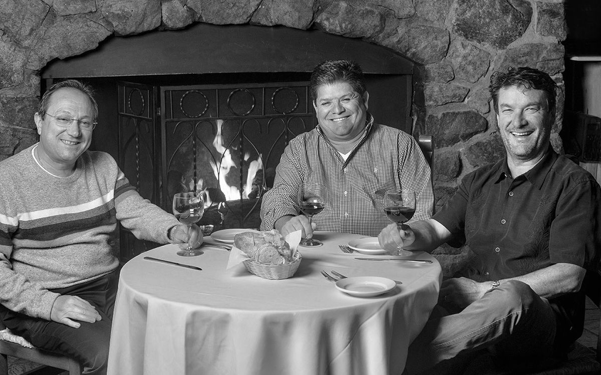 Giovanni Marzoccca, José Marquez, and Roberto Pugliese in front of fireplace at mezza luna
