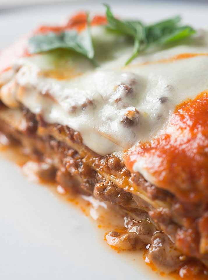 close up of lasagna with basil leaves on top