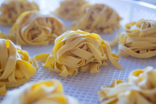fresh uncooked pappardelle pasta in individual-size bundles