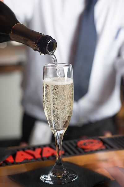 bartender pouring champagne in flute